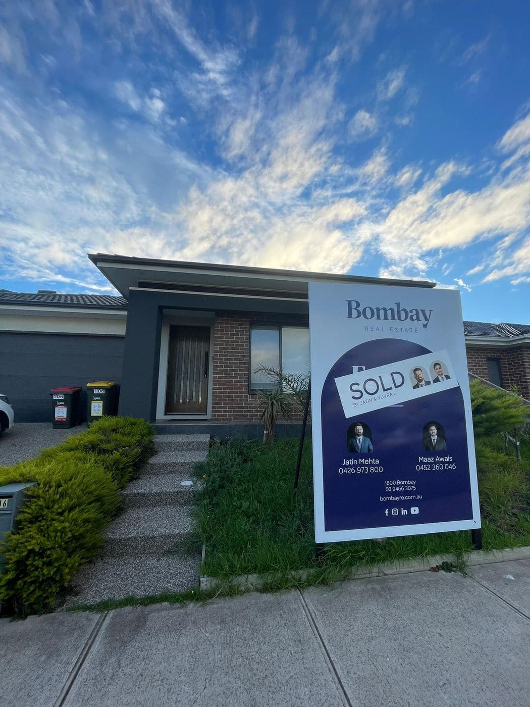 A sold board outside a rendered double-storey home